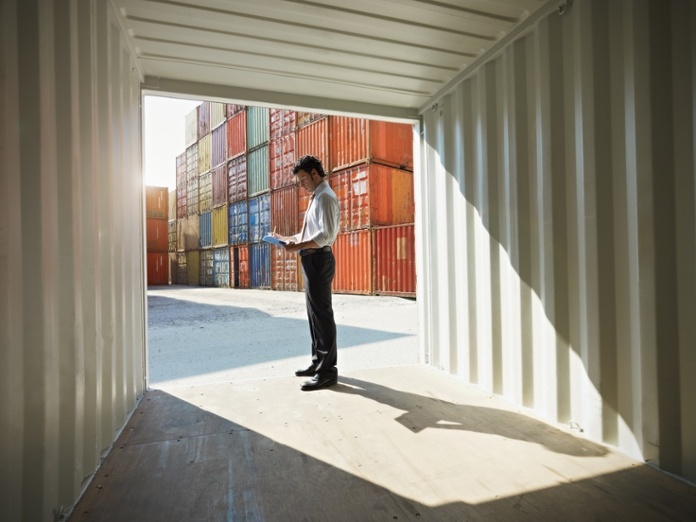 Business man with shipping containers.jpg