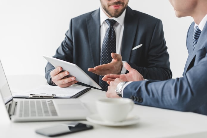 Business people with tablet at workplace