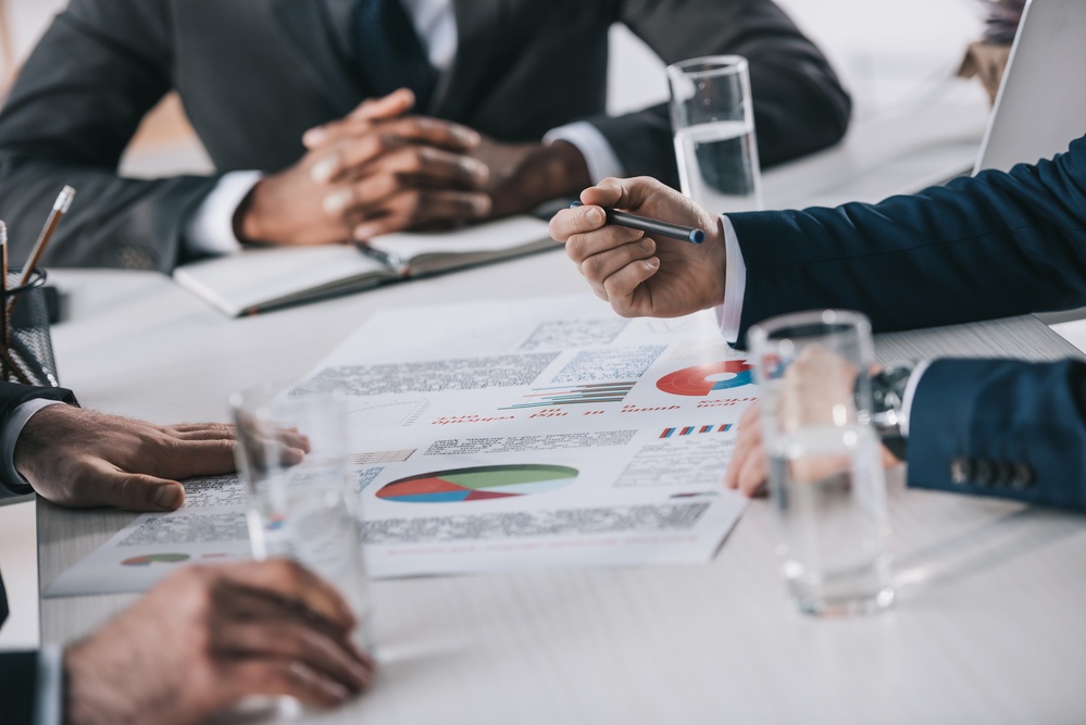 Hands of businessmen on table