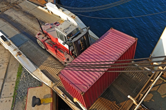 Loader with container entering ship.jpg