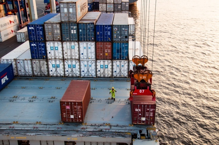 Worker assisting container uploading at dock.jpg
